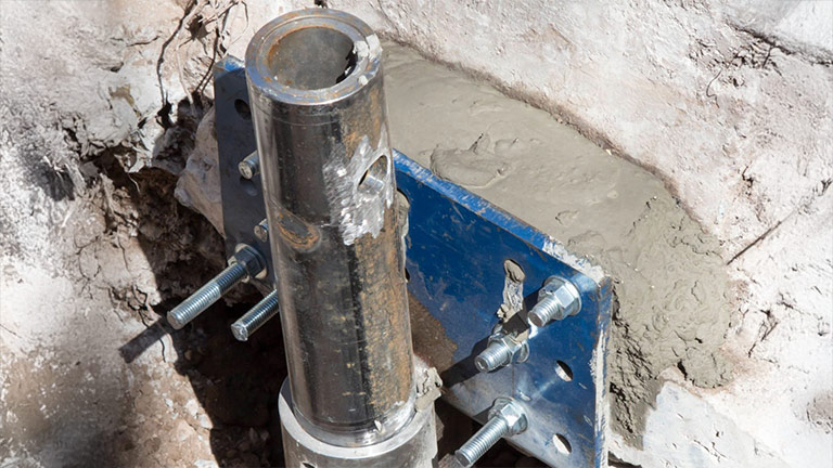 A foundation pier holding against concrete wall